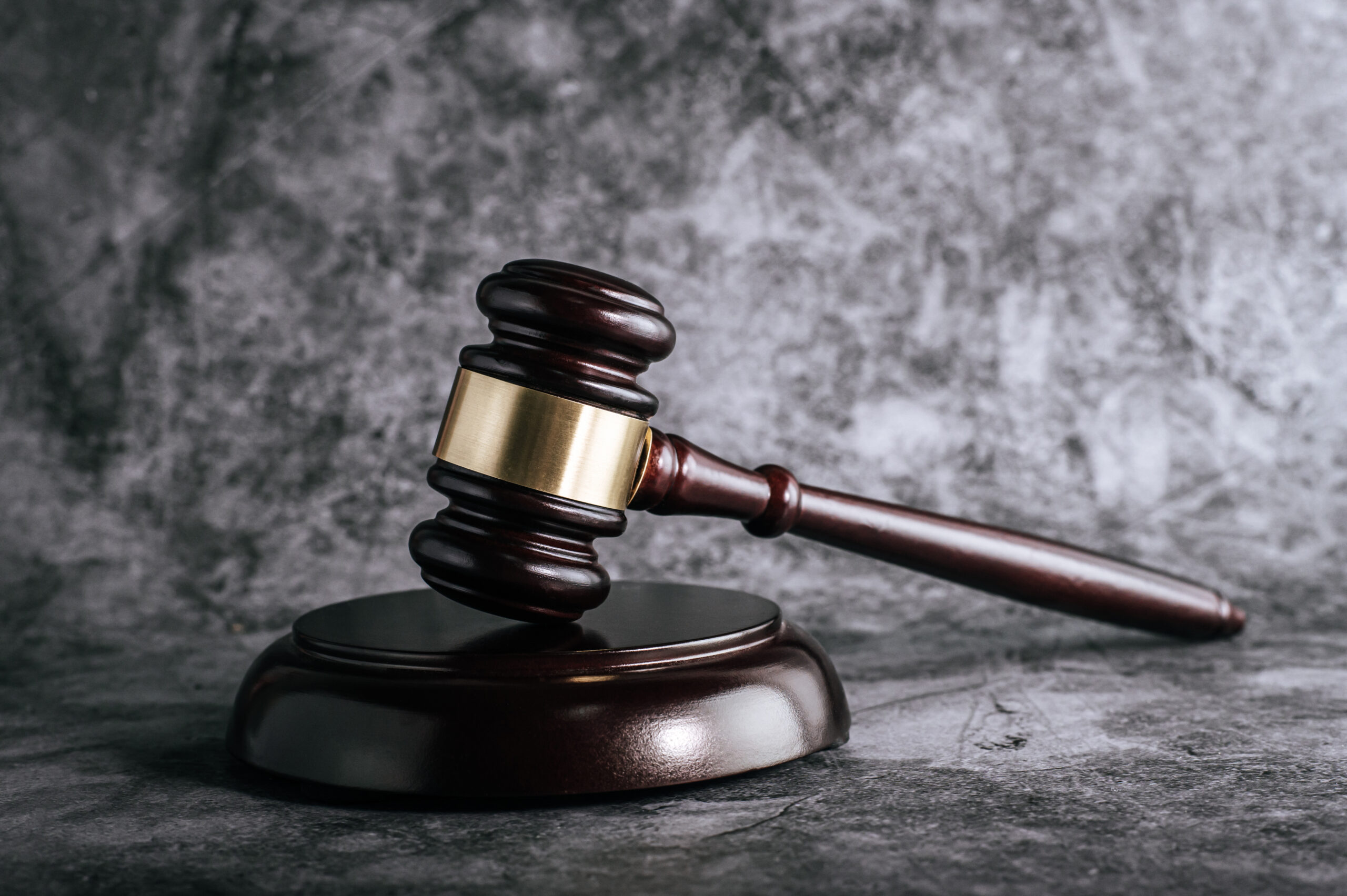 wooden judges gavel on table in a courtroom or enforcement offic